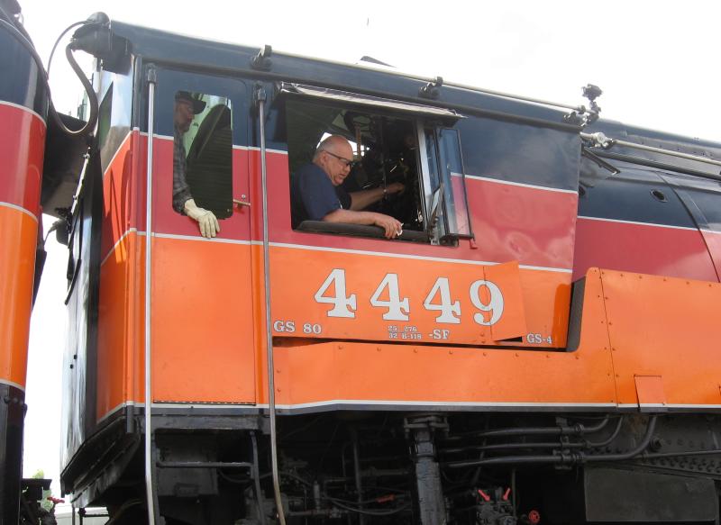 Closeup of cab of 4449, with two crew members visible in it